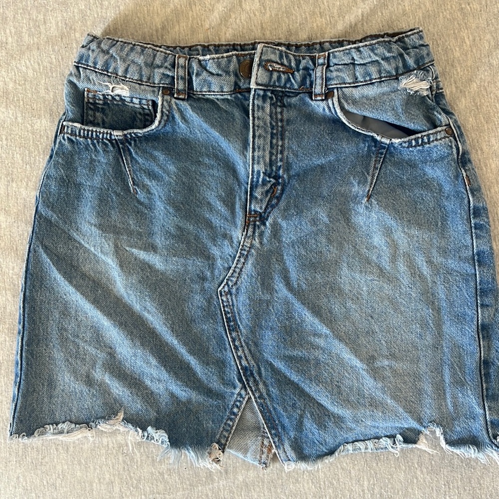 girls denim skirt with frayed edges and a small slit in the middle